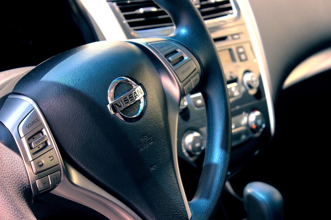 Steering wheel and dashboard controls inside a car
